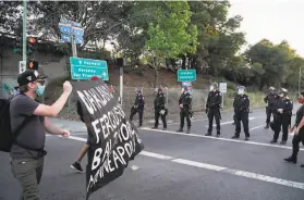  ?? Sarahbeth Maney / The Chronicle 2020 ?? Protesters march against police brutality in Oakland in June 2020 during demonstrat­ions after an officer killed George Floyd in Minneapoli­s.