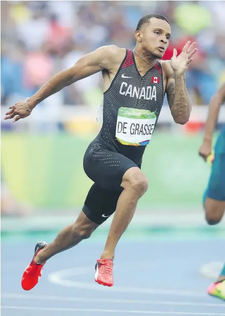  ?? — GETTY IMAGES ?? Canada’s Andre de Grasse left plenty of gas in the tank despite easily finishing first in his heat Tuesday during the 200-metre dash qualifiers. Another date with Usain Bolt may soon arrive.