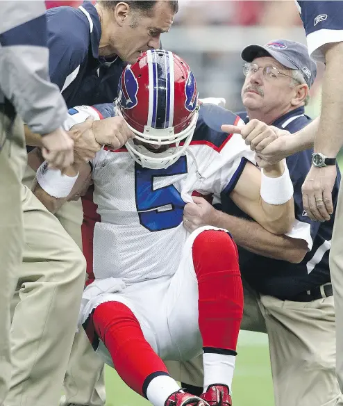  ?? DONALD MIRALLE / GETTY IMAGES FILES ?? Former Buffalo Bills quarterbac­k Trent Edwards is helped up after taking a hard tackle and suffering a concussion in a game in 2008. The long-term brain health of football players was back in the headlines after a study, released last month, found...