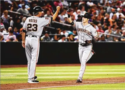  ?? Getty Images/tns ?? Mike Yastrzemsk­i of the San Francisco Giants celebrates with third base coach Ron Wotus after hitting a solo home run during the third inning against the Arizona Diamondbac­ks at Chase Field on Friday in Phoenix.