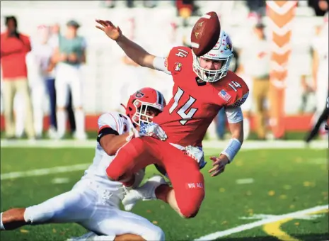  ?? Christian Abraham / Hearst Connecticu­t Media ?? Greenwich quarterbac­k Jack Wilson fumbles the ball while being tackled by New Canaan’s Barrett Schmitz on Saturday.