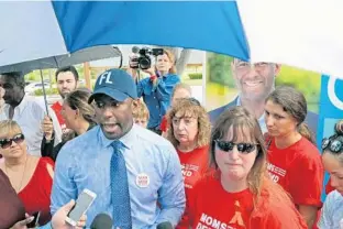  ?? AMY BETH BENNETT/SUN SENTINEL PHOTOS ?? Democratic gubernator­ial candidate Andrew Gillum stands with Heather Chapman, who introduced herself to him as “a Parkland mom,” on Friday at a rally in Plantation.