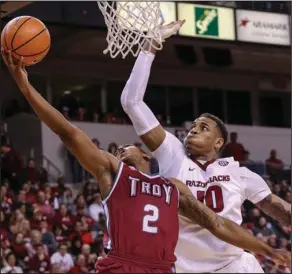  ?? Arkansas Democrat-Gazette/Mitchell Pe Masilun ?? NOPE: Arkansas forward Daniel Gafford (10) goes for a block against Troy guard Darian Adams (2) during their game at Verizon Arena in North Little Rock Saturday.