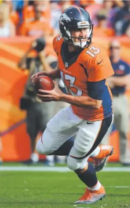  ?? Helen H. Richardson, The Denver Post ?? Quarterbac­k Trevor Siemian scrambles during the Broncos’ first meeting this season against the Kansas City Chiefs before throwing a touchdown pass to wide receiver Jordan Taylor.