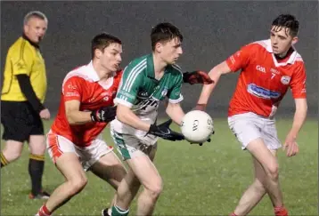  ??  ?? Kyle Murphy of Cloughbawn under pressure from Ian Hawkins and Matthew Rochford.