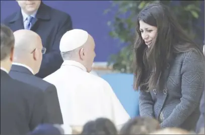  ?? Ap photo ?? Pope Francis meets Nour Essa, part of a group of Syrian refugees who arrived in Rome with Pope Francis from the Greek island of Lesbos, at the Roma Tre University in Rome.