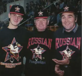  ?? Red Penguins Doc LLC ?? Three hockey fans show off their merchandis­e at the Moscow Ice Palace circa 1994 in Gabe Polsky's documentar­y, "Red Penguins.'