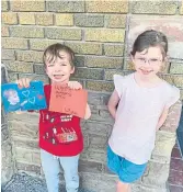  ?? Bronwen Alsop’s son, Liam, holds up the cards he made in school for Mother’s Day. His sister, Emma, was empty-handed because her school has replaced the holiday with “Grownups Who Love Us Day” to be marked on May 27. ALSOP FAMILY PHOTO ??