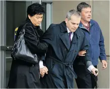  ?? Gavin Young/calgary Herald ?? Doug de Grood, centre, and his wife, Susan, leave the Calgary Courts Centre on Friday morning following a hearing for their son, Matthew de Grood, who is accused in the Brentwood murders.