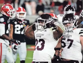  ?? BRYNN ANDERSON/AP ?? Mississipp­i State running back Dillon Johnson celebrates after he scores a touchdown against Georgia in the first half on Nov. 21 in Athens, Ga.