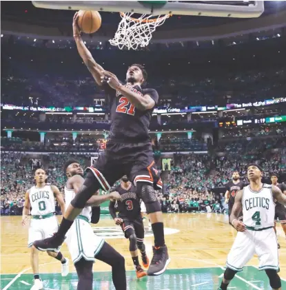  ?? | CHARLES KRUPA/ AP ?? Bulls star Jimmy Butler slashes through the Celtics’ defense on his way to the basket in the first quarter Tuesday.