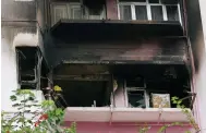  ?? Photo: May Tse ?? The burnt-out flat at Kam Lok Mansion on Lockhart Road, Wan Chai. The case is being classified as murder, suicide and arson.