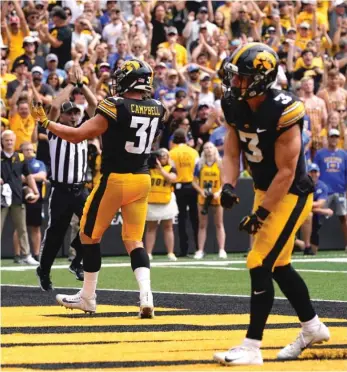  ?? CHARLIE NEIBERGALL/AP ?? Iowa’s Jack Campbell and Cooper DeJean celebrate after a safety during the second half.