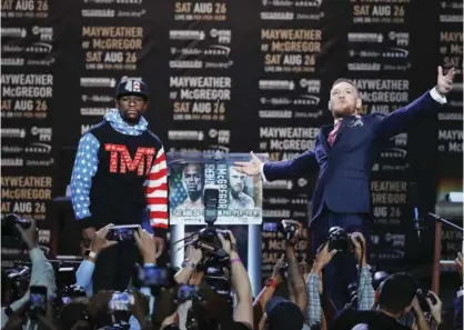  ??  ?? LAS VEGAS: File photo shows Floyd Mayweather Jr., left, and Conor McGregor pause for photos during a news conference at Staples Center on July 11, 2017, in Los Angeles. The two will fight in a boxing match in Las Vegas on Aug 26. — AP
