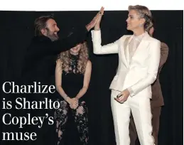  ?? PICTURE: TODD WILLIAMSON/JANUARY IMAGES ?? HIGH FIVE: Sharlto Copley and Charlize Theron.