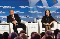  ?? (Reuters) ?? RUSSIAN PRESIDENT VLADIMIR PUTIN (L) and Meng Wanzhou, Executive Board director of the Chinese technology giant Huawei, attend an investment forum in Moscow in 2014.
