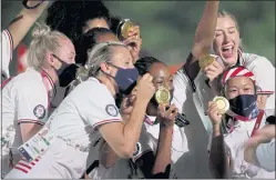  ?? EZRA SHAW — GETTY IMAGES ?? Members of Team USA show off their medals during the closing ceremony of the Tokyo Olympic Games on Sunday. U.S. athletes won the most medals of the Games.