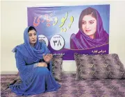  ?? REUTERS ?? Female Afghan parliament­ary election candidate, Dewa Niazai, sits in front of her poster during an election campaign in Jalalabad, Afghanista­n.