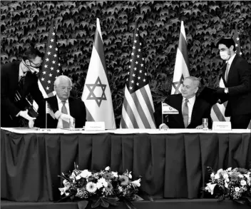  ?? Emil Salman/Pool via AP ?? Israeli Prime Minister Benjamin Netanyahu (second right) and U.S. Ambassador to Israel David Friedman (second left) attend a ceremony to sign amendments to a series of scientific cooperatio­n agreements, at Ariel University, in the West Bank settlement of Ariel, on Wednesday.