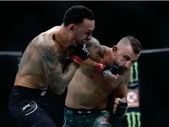  ??  ?? Max Holloway (left) dropped his belt to Alexander Volkanovsk­i via unanimous decision (Getty)