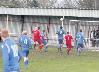 ??  ?? Asa Thomas (top left) leads an attack for Holyhead Hotspur while Steven Whittaker (furthest left - red) scores for Cemaes Bay. He lines up for Bodedern Athletic this term