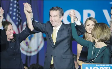  ??  ?? Virginia governor-elect Ralph Northam celebrates his election victory with his wife, Pam, and daughter Aubrey, right, and Dorothy McAuliffe, wife of Virginia Gov. Terry McAuliffe, during an election night party at George Mason University in Fairfax,...