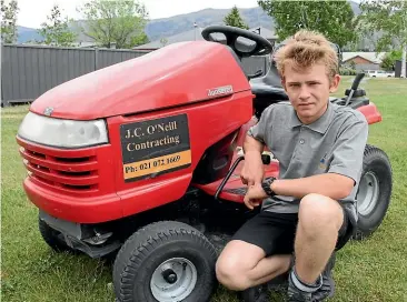  ??  ?? Johnny O’Neill, 14, owns and manages his own garden maintenanc­e company but has been banned from driving his rideon mower on the streets of Cromwell.