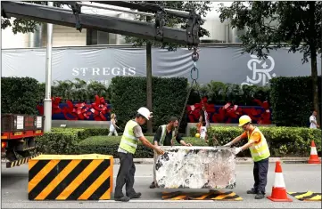  ??  ?? A warning sign is seen placed along the roadside outside the ShangrLa hotel.