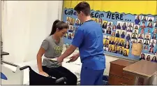  ?? / Floyd County Schools ?? Floyd County high school students Ethan Temples and Maycy Owens demonstrat­e a transfer skill as part of their certified nursing assistant training at the college and career academy.