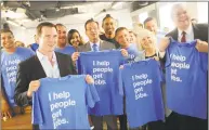  ?? Tyler Sizemore / Hearst Connecticu­t Media ?? Front row, from left, Indeed SVP and CFO Dave O’Neill, Gov. Dannel P. Malloy, state Department of Economic and Community Developmen­t Commission­er Catherine Smith and Stamford mayor David Martin hold up company T-shirts with employees after speaking at the Indeed headquarte­rs in Stamford in 2017.