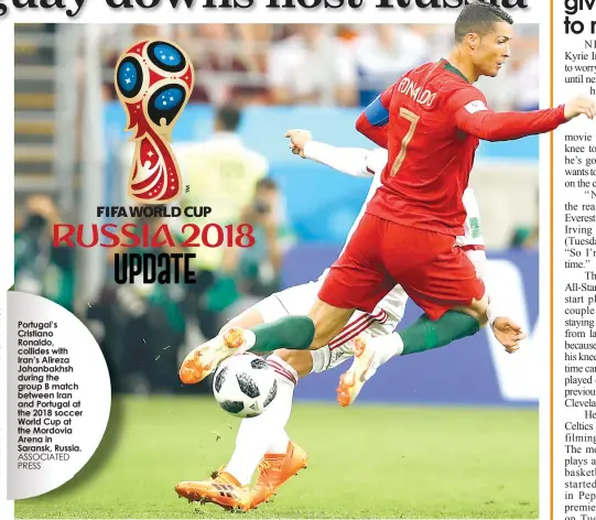  ?? ASSOCIATED PRESS ?? Portugal’s Cristiano Ronaldo, collides with Iran’s Alireza Jahanbakhs­h during the group B match between Iran and Portugal at the 2018 soccer World Cup at the Mordovia Arena in Saransk, Russia.