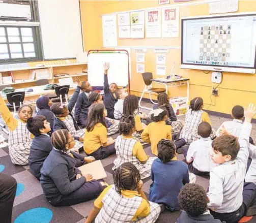  ??  ?? Kids soak in a lesson at Success Academy Harlem 1 charter school. A group of charter schools is suing over being excluded from the city’s public school COVID-19 testing program.