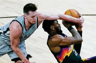  ?? Rick Scuteri / Associated Press ?? Drew Eubanks, left, started for Jakob Poeltl and posted a double-double, including a career-high 13 rebounds. Eubanks also helped hold the Suns’ Deandre Ayton, right, to eight points.