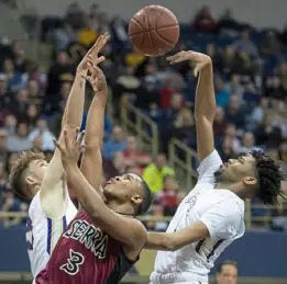  ??  ?? Serra Catholic’s Khalil Smith has his shot blocked by Our Lady of the Sacred Heart’s Ricco Tate.