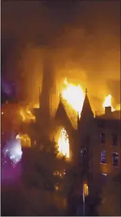  ?? DUKE TODD VIA AP ?? Firefighte­rs work to extinguish a fire that erupted from a building next to Middle Collegiate Church on Saturday in New York. The church includes the state’s Liberty Bell.