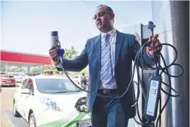  ?? Picture: Jacques Nelles ?? GOING GREEN. Hiten Parmar, director of uYilo eMobility programme, demonstrat­es how to charge a Nissan LEAF yesterday.