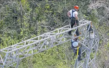  ?? Ramon Espinosa/Associated Press ?? Whitefish Energy Holdings workers restore power lines last week damaged by Hurricane Maria in Barcelonet­a, Puerto Rico. Whitefish said previous work restoring transmissi­on lines damaged by wildfires in the western U.S. prepared them for the Puerto Rico...
