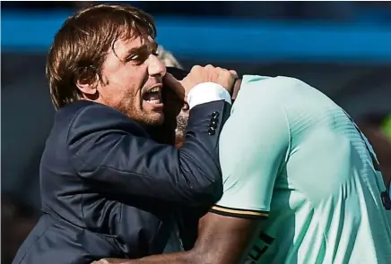  ?? — AFP ?? That’s my boy: Inter Milan’s Romelu Lukaku (right) celebrates with coach Antonio Conte after scoring his first goal during the Serie A match against Sassuolo on Sunday.