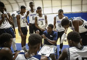  ?? JANE HAHN PHOTOS / THE NEW YORK TIMES ?? Basketball players review their strategy at the NBA Academy in Saly, Senegal. The NBA is planning a new league, the Africa League, and has set up youth training facilities.