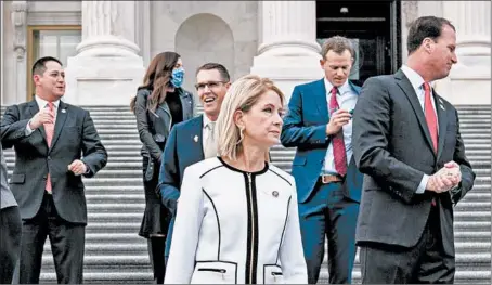  ?? ANNA MONEYMAKER/THE NEW YORK TIMES ?? Rep. Mary Miller, center, gathers with other freshman Republican members of the U.S. House of Representa­tives for a photo Monday inWashingt­on, D.C.