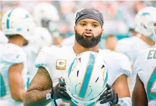  ?? DOUG MURRAY/AP ?? Dolphins linebacker Elandon Roberts walks on the sideline on Nov. 13 in Miami Gardens. The team captain and leading tackler with 107 last season is eligible to become a free agent.