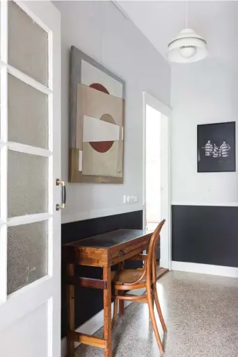  ??  ?? LEFT Hedda chose Farrow &amp; Ball’s Blackened to create a neutral base on the walls throughout the living areas, which in the hallway picks up on the pale flecks in the original terrazzo flooring. BELOW The open-plan kitchen and dining area is housed in a new extension at the back of the house.