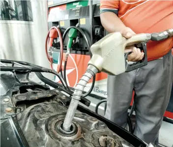  ?? SUNSTAR FOTO / ARNI ACLAO ?? HARD TIMES. Drivers’ group Piston sees a total of P13.75 increase in gasoline price and P13.50 for diesel since January this year. The increases came in eight batches.