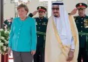  ??  ?? German Chancellor Angela Merkel stands next to Saudi Arabia’s King Salman bin Abdulaziz al-Saud during a welcoming ceremony in Jeddah on Sunday. —