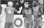  ?? Canadian Press photo ?? Toronto FC forward Jozy Altidore (17) celebrates his goal with midfielder Victor Vazquez (7) and midfielder Michael Bradley (4) during second half MLS eastern conference final playoff soccer action against the Columbus Crew in Toronto on Wednesday.