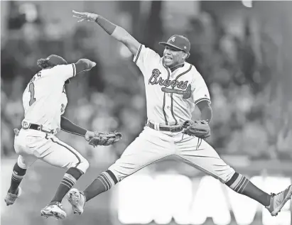  ?? DALE ZANINE/USA TODAY SPORTS ?? Braves second baseman Ozzie Albies and left fielder Ronald Acuna Jr., right, celebrate after defeating the Phillies at SunTrust Park in Atlanta on Sept. 21.