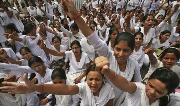  ?? Reuters ?? A rally in India’s Jammu city. Discrimina­tory laws and practices across the world prevent women from working or starting businesses, says a World Bank report