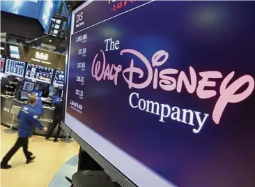  ?? — AP ?? Higher bid: Walt Disney Co logo appears on a screen above the floor of the New York Stock Exchange. Thanks to Comcast’s late-stage competing bid that Disney was driven to pay nearly US$20bil more than it originally intended to 21st Century Fox Inc.