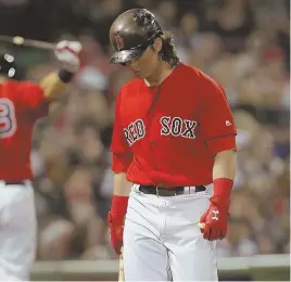  ?? STAFF PHOTO BY JOHN WILCOX ?? HANGING IN THE BALANCE: Andrew Benintendi walks back to the dugout after striking out in the eighth inning of the Red Sox’ 3-2 loss to the Houston Astros last night at Fenway.