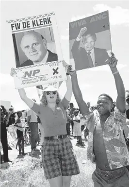  ?? JOHN PARKIN/AP 1994 ?? A National Party supporter, left, and an African National Congress supporter try to outshout each other during an election rally in Bethal, South Africa.